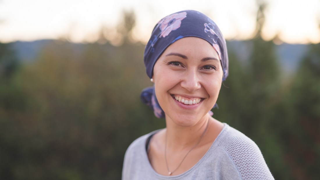 Beautiful woman wearing a purple headscarf, tied in the classic style after learning how to tie a headscarf.